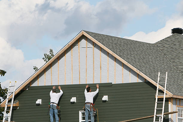 Professional Storm Damage Siding Repair technician working in Laughlintown, PA